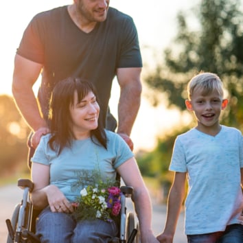 A woman in a wheelchair with her family